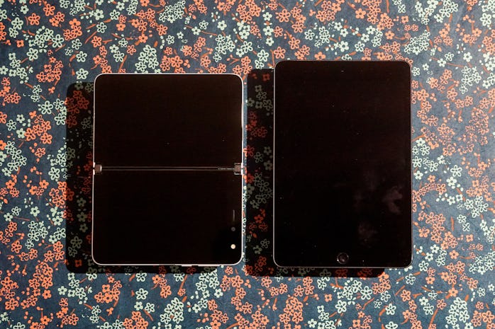 The Surface Duo unfolded next to an iPad mini.