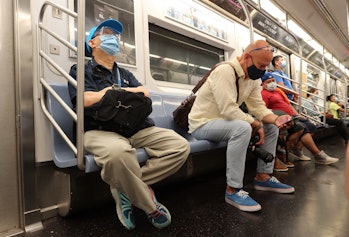 People on the 7 train in NYC wearing masks.