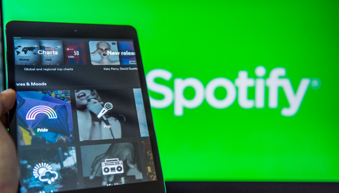 A man holds an Apple iPad Mini as he uses Spotify app on October 11, 2017 in Hong Kong, Hong Kong.