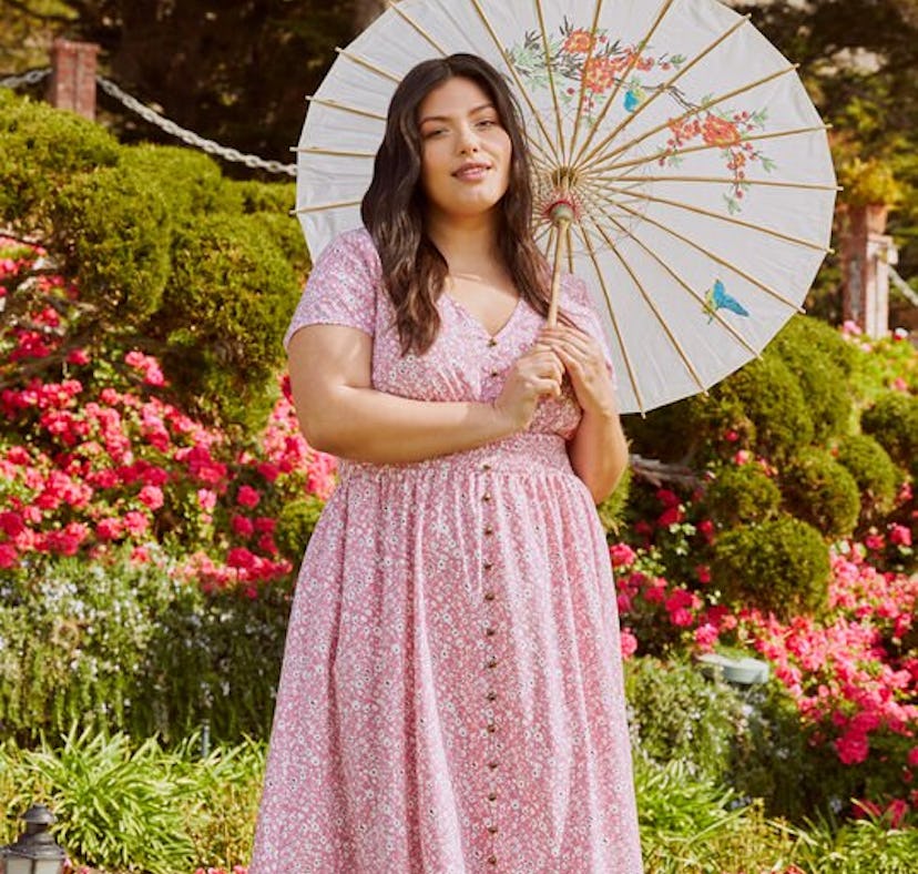 Woman dressed in a cottagecore-style dress with a parasol.