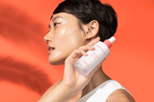 Peach & Lily Glass Skin Veil Mist after photo, held by model.