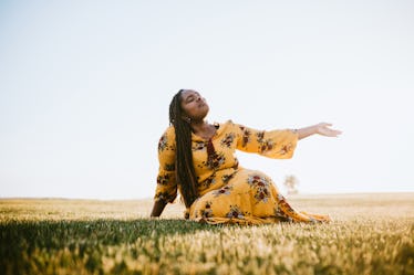 Praying Black woman in field