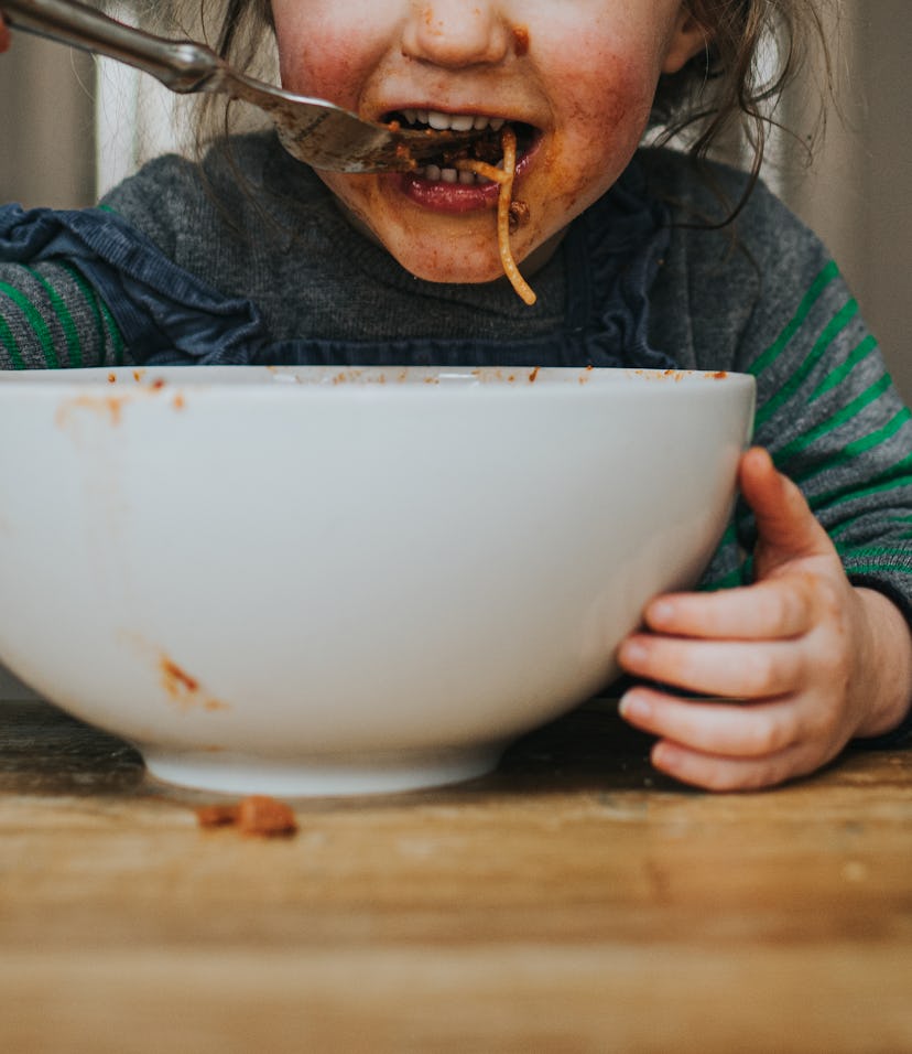 Child eating spaghetti made from slow cooker