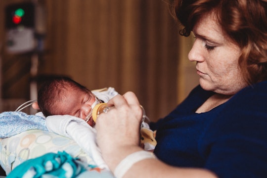 mother feeding baby in the NICU