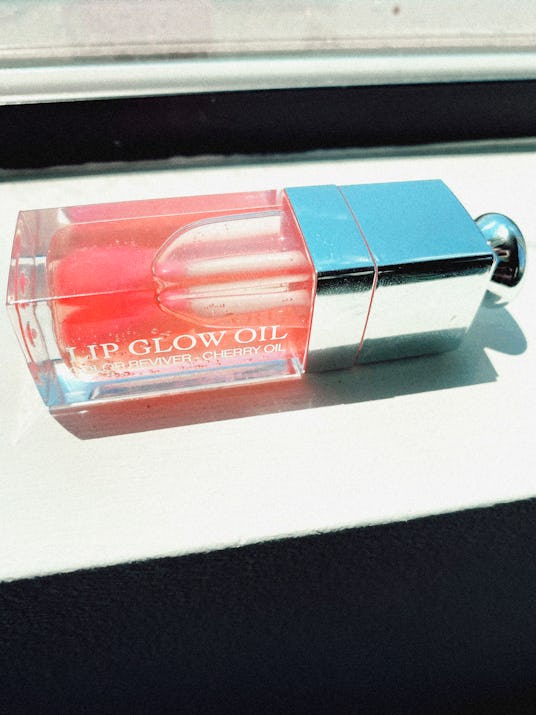 Dior Lip Glow Oil product laying on a white surface