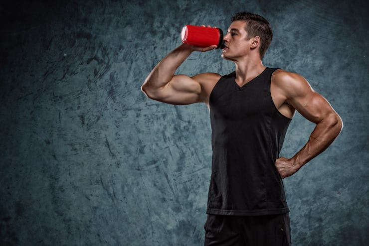A man drinks a protein supplement shake.