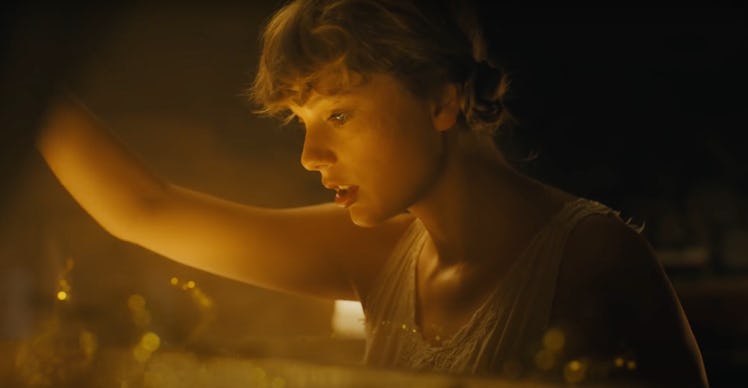 Taylor Swift opens the top of her piano to find a gold and glittery abyss in her "cardigan" music vi...