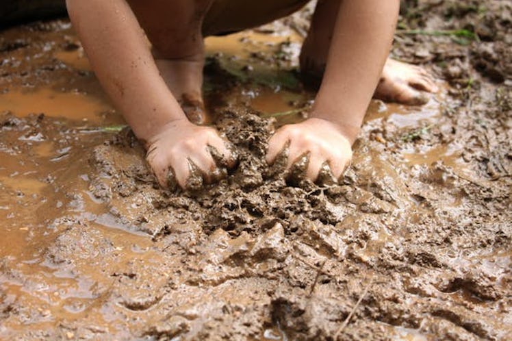 A child playing in mud, as biodiversity is necessary for the development of a healthy immune system