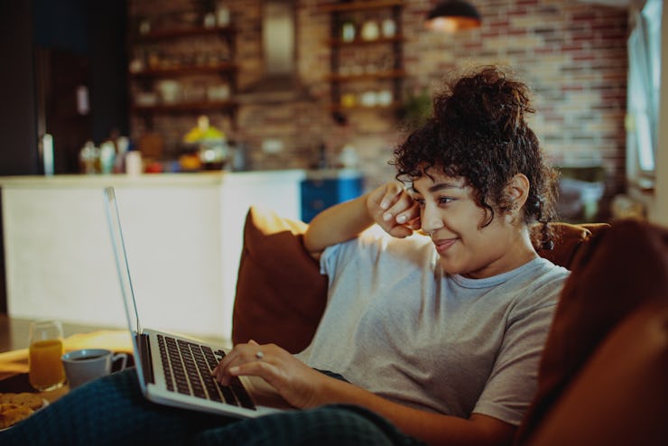 Woman working on laptop at home.