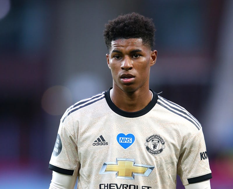 Marcus Rashford pictured playing football in a light gold and blue shirt