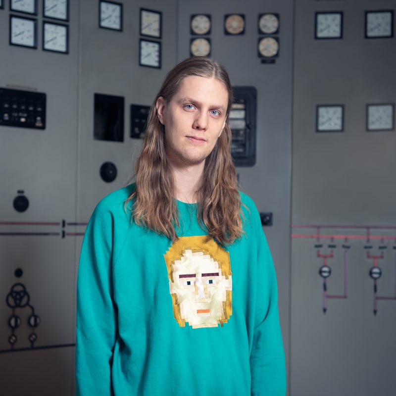 Eurovision breakout Daði Freyr in a blue sweatshirt with yellow print, standing and posing