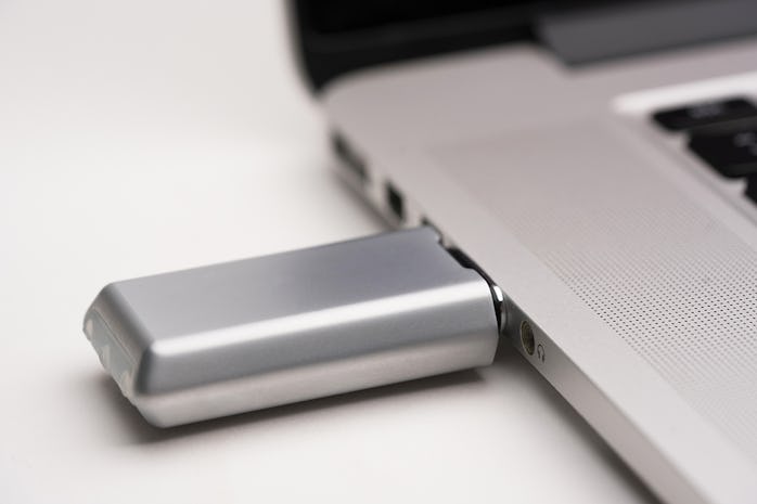 Crave's Duet Pro vibrator plugged into a laptop USB port