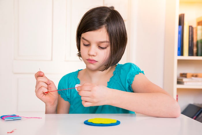 Young girl sewing arts and crafts project