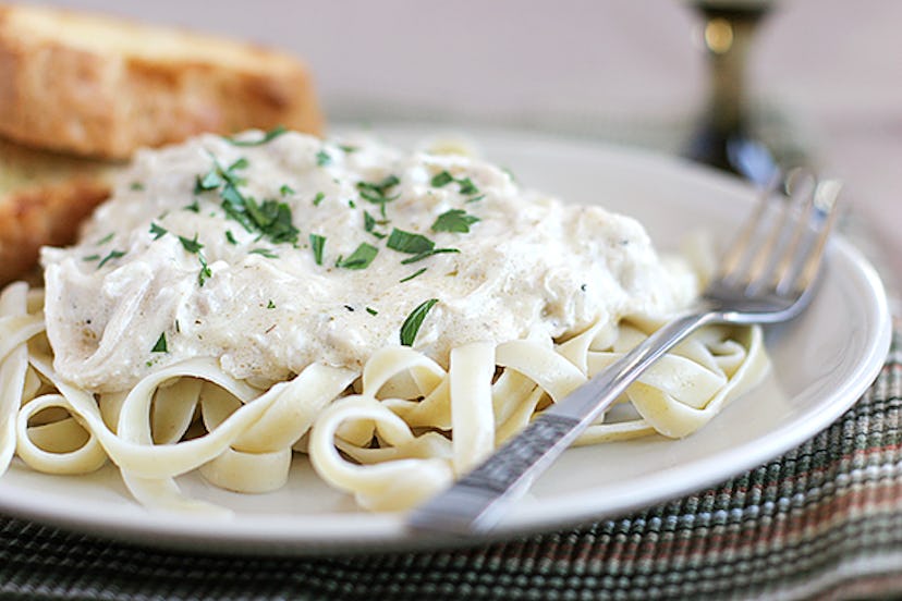 Chicken fettucine on white plate with a fork