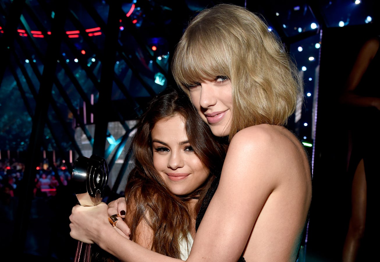 Recording artists Selena Gomez (L), winner of the 'Biggest Triple Threat' award, and Taylor Swift, w...