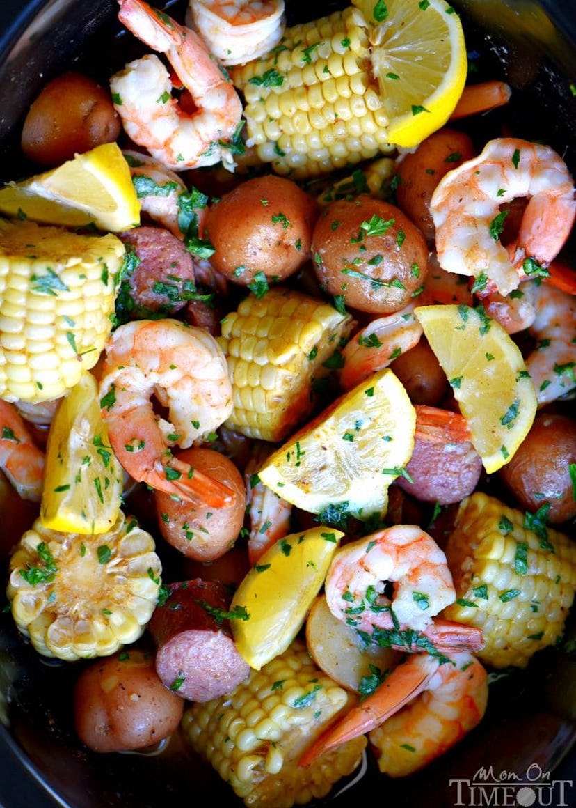 Shrimp boil (shrimp, corn, potatoes, lemons) on a plate