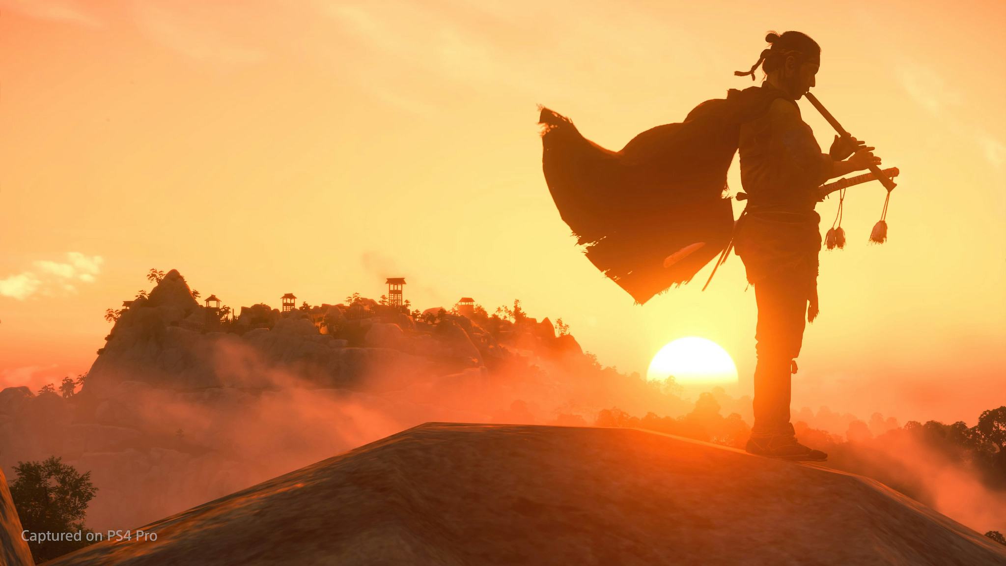 A character from Ghost of Tsushima playing on an instrument with the sunset in the background