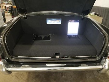 Electric Rolls-Royce with a Tesla touchscreen installed in the trunk.