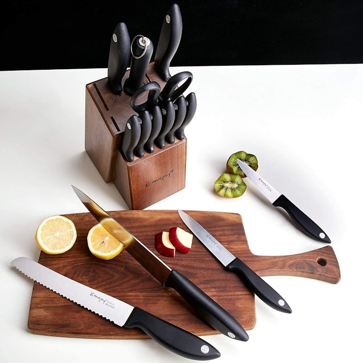 Emojoy Knife Set with four of them on a brown wooden cutting board