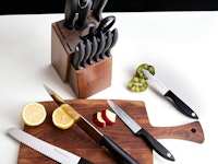 Emojoy Knife Set with four of them on a brown wooden cutting board