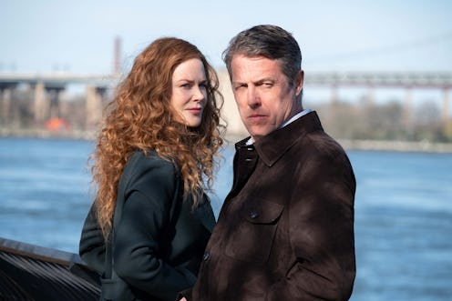 Nicole Kidman and Hugh Grant stand by the banks of a river in a still from The Undoing
