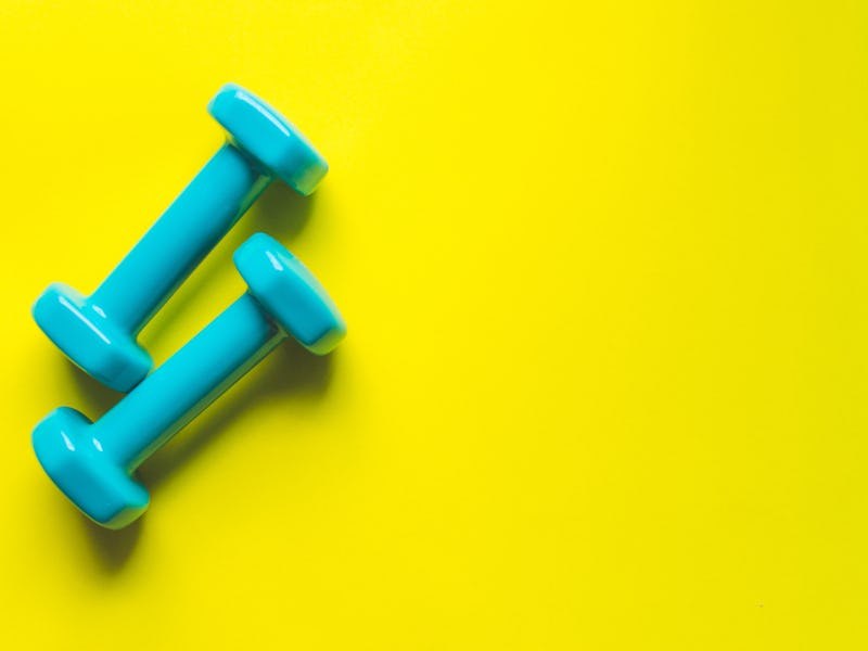 Dumbbells on a yellow background.