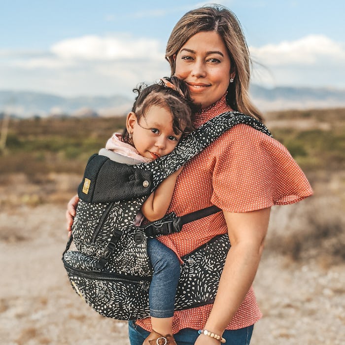 Promotional picture of woman wearing her toddler using the SeatMe