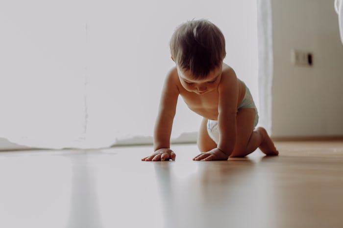 pediatrician advice on how to treat constipation in babies: photo of baby crawling in diaper 