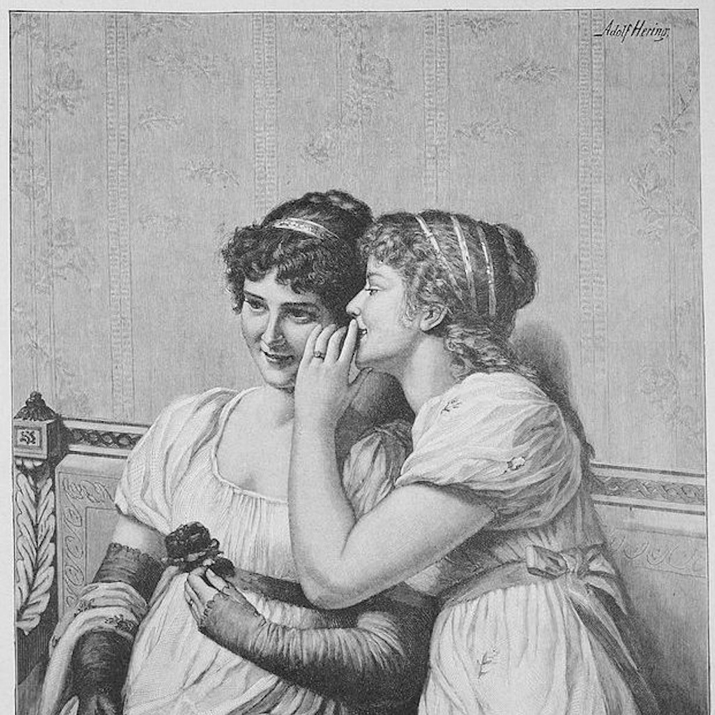 Two girls whisper. Being soft-spoken can help stop the spread of COVID-19.