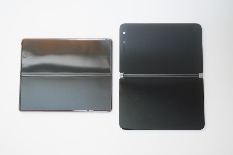 The Fold 2 (left) and its crease-and-all bendable display. The Surface Duo (right) with its big beze...