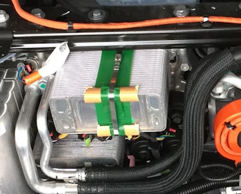 Tesla's Model Y shown with a cooling system held together using wood trim pieces.