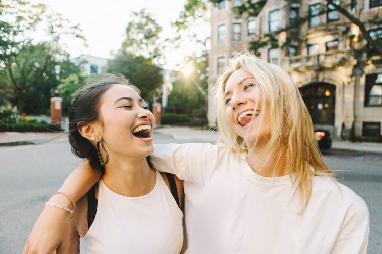 2 young female friends laughing