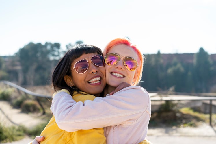 2 young female friends hugging