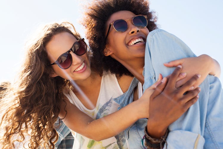 2 young female friends hugging