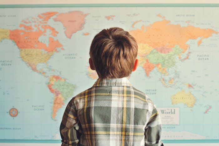 kindergarten student looking at a map in the classroom
