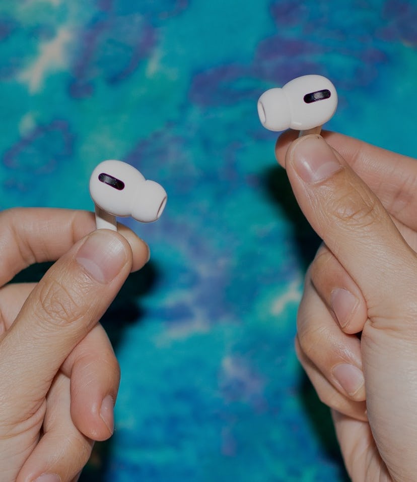 A man holding Apple AirPods Pro.