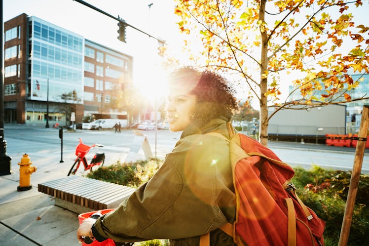 Young woman riding bike in autumn