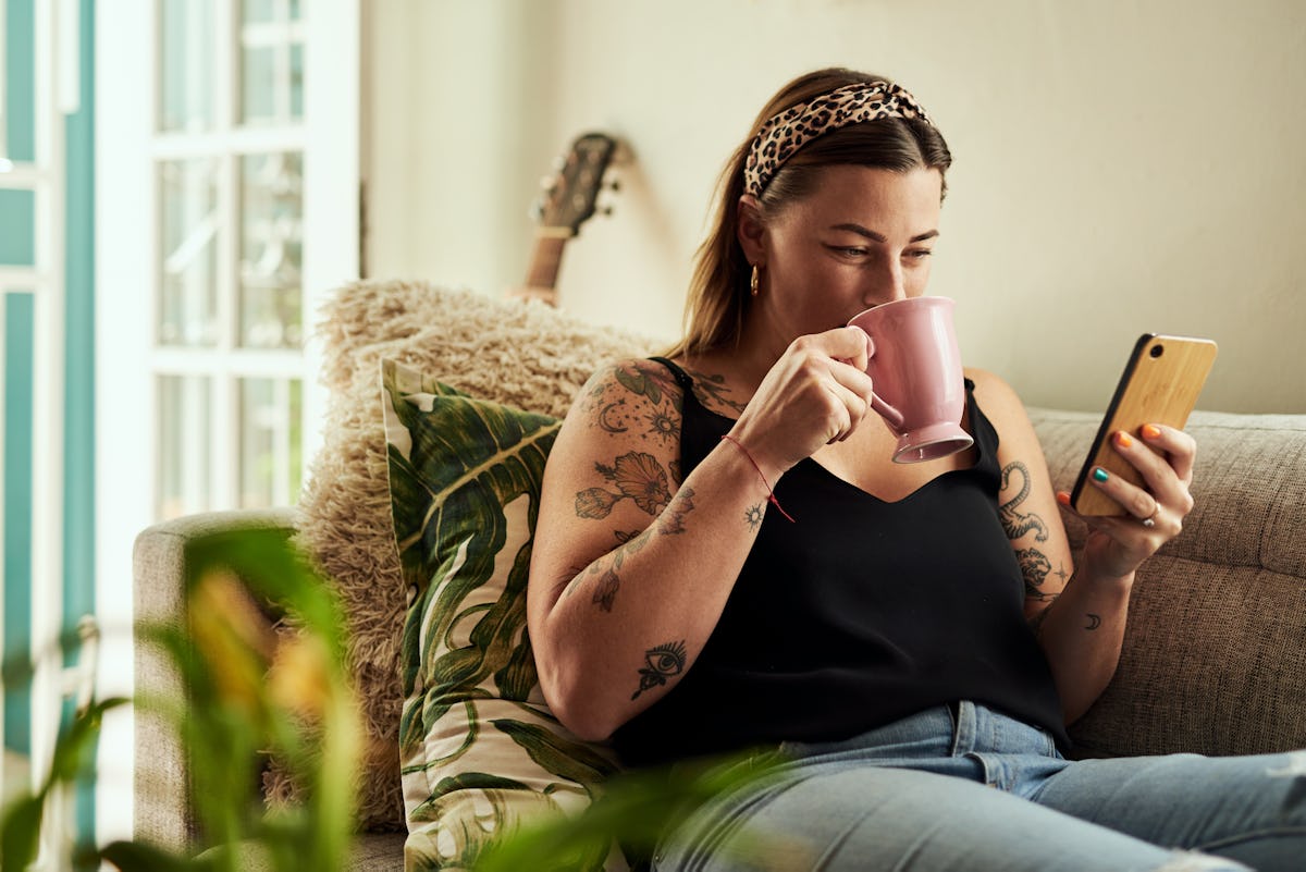 Tattooed woman drinking coffee