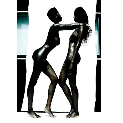 Two naked Black women standing powerfully.