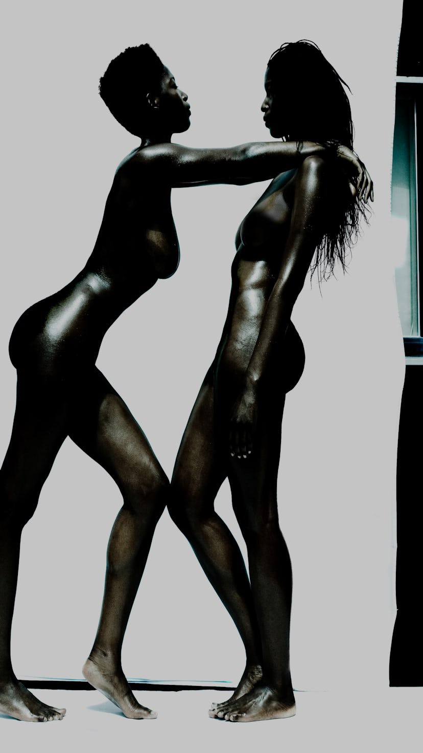 Two naked Black women standing powerfully.