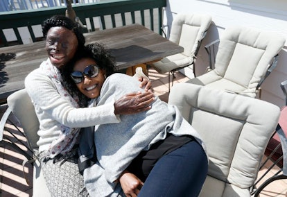 Atsede Niguse, left, hugs Menbere Aklilu on the deck at Aklilu’s home in Richmond, California, in 20...