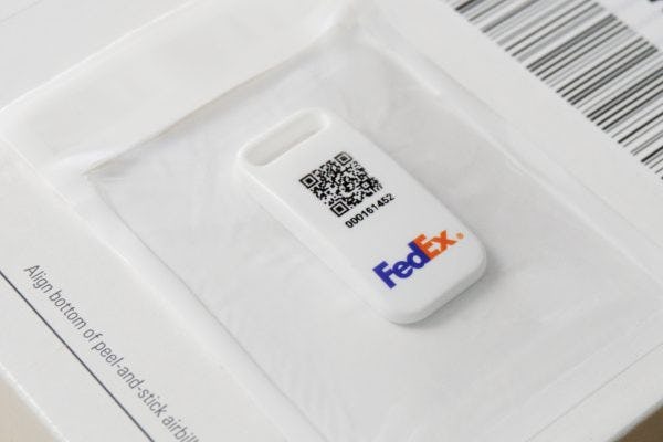 The SenseAware ID, a Bluetooth tracking device, on a FedEx package.