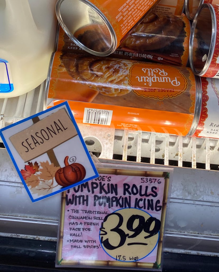 Images of a few tubes of pumpkin spice cream cheese roll behind a price tag.