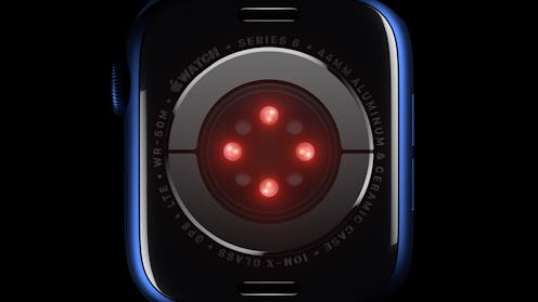 The back of an Apple Watch, projecting four points of red light. The Apple Watch Series 6 will be ab...