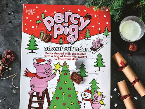 A percy pig advent calendary pictures with a glass of milk and some crackers