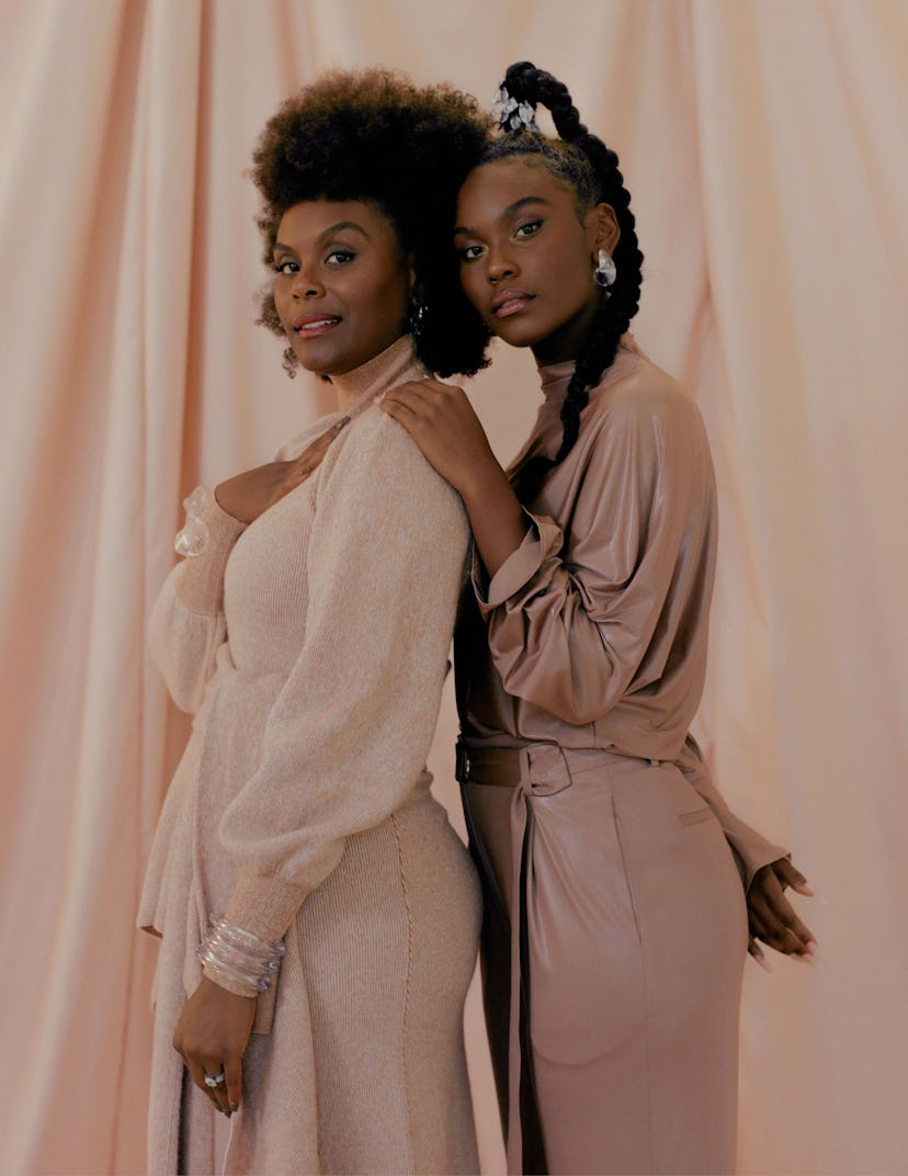 Tabitha & Choyce Brown posing in a light brown leather jumpsuit and a beige jumpsuit 