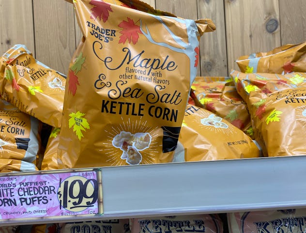 Bags of maple kettle corn in golden bags on a shelf.