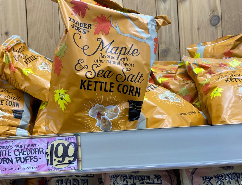 Bags of maple kettle corn in golden bags on a shelf.