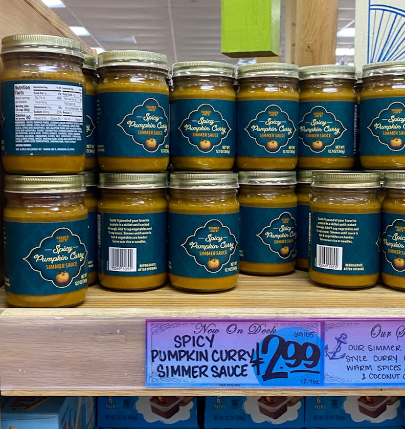 An image of several jars of brownish, pumpkin flavored curry on a shelf. 
