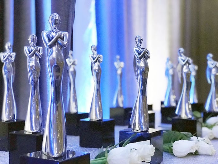 A variety of Mom 2.0 award sculptures in silver and black